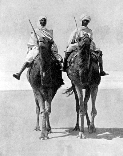 अफ्रीका के सहारा रेगिस्तान में दो अरब लोग ऊंट की सवारी करते हैं, 1936। द्वारा फॉक्स तस्वीरें