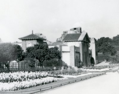 1928 में लंदन चिड़ियाघर में रेप्टाइल हाउस, लंदन चिड़ियाघर के प्रवेश द्वार के रास्ते में औपचारिक फूलों की क्यारियों के साथ द्वारा फ्रेडरिक विलियम बॉन्ड
